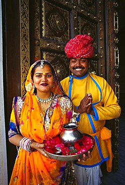 Portrait of a mid adult couple at a door and greeting, Jaipur, Rajasthan, India