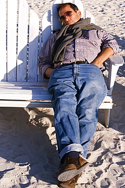 Mature man sleeping on a bench