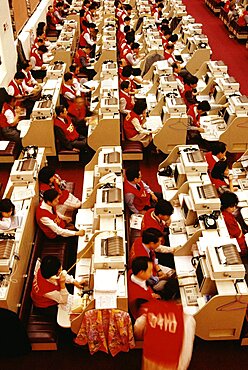 High angle view of businessmen and businesswomen working at a stock exchange, Hong Kong, China