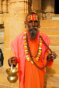 Portrait of a sadhu holding a vase, Jaisalmer, Rajasthan, India