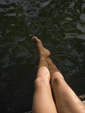 High angle view of woman's legs in water