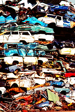 Close-up of a heap of cars in a junkyard