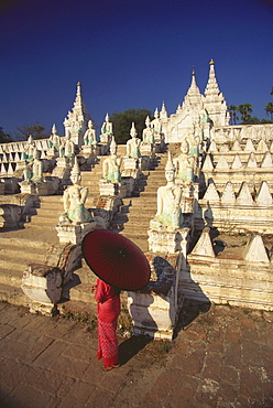 High angle view of a woman holding a parasol and standing in front of a pagoda, Mingun, Sagaing Divison, Myanmar