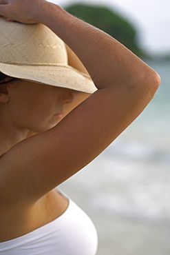 Close-up of a young woman wearing a sun hat