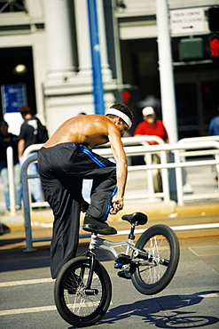 Rear view of a man performing tricks on a cycle, San Francisco, California, USA