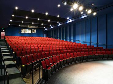 Empty auditorium, rows of raked seats.