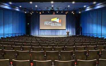 Empty auditorium, rows of raked seats.