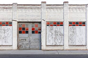 A boarded up building, a closed business on Main Street.