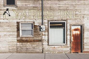 Old wooden building on Main Street, boarded up windows.