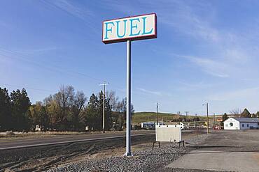 Fuel sign for rural gas station in a small town.