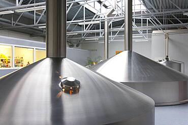 Interior of brewery, large steel storage tanks for brewing beer.