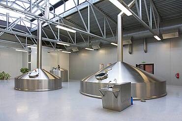 Interior of brewery, large steel storage tanks for brewing beer.