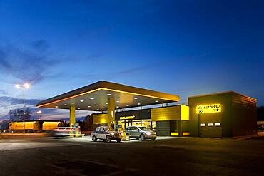 Gas station, petrol station on a road at dusk.