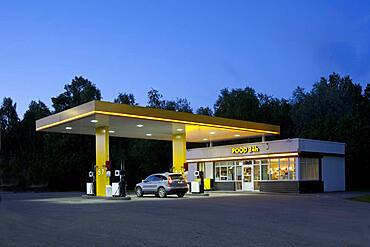 Gas station, petrol station on a road at dusk.