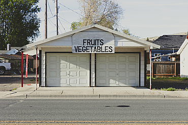 Fruits and Vegetables sign and a closed market stall on a small town street