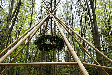 Wooden structure with wreath for a woodland naming ceremony.