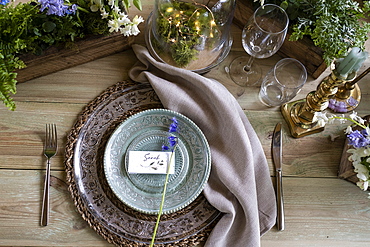 High angle close up of rustic place setting for a woodland naming ceremony.