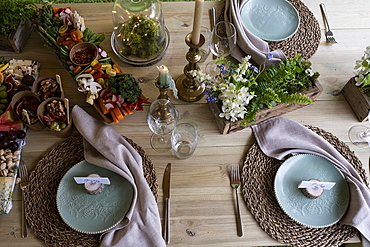 High angle close up of rustic place setting for a woodland naming ceremony.