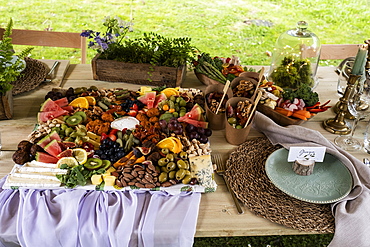 Rustic place setting for a feast and naming ceremony in a forest.