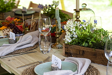 High angle close up of rustic place setting for a woodland naming ceremony.