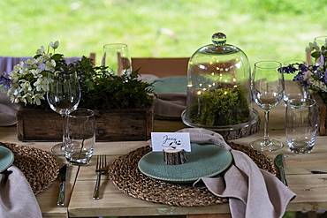 High angle close up of rustic place setting for a woodland naming ceremony.