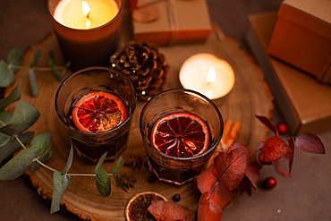 Christmas, wine glasses of mulled wine, lit candles and table decorations