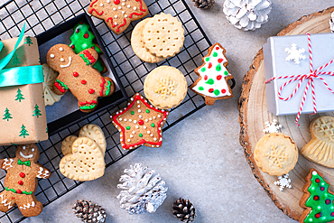 Overhead view of Christmas cookies and biscuits, and Christmas ornaments.