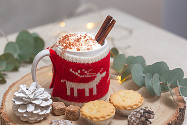 Christmas, mince pies and mug of hot chocolate or eggnog with a knitted wraparound cover