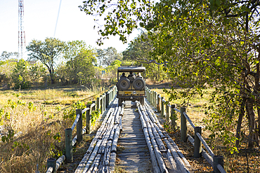 Safari vehicle crossing Fourth Bridge, Okavango Delta, Botswana.