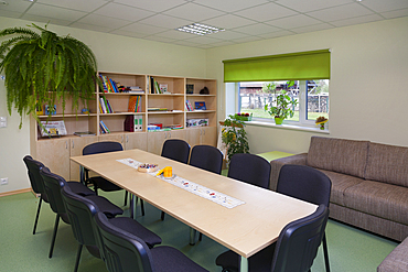 Modern day care nursery or pre-school kindergarten, spacious interiors, room with tables and chairs