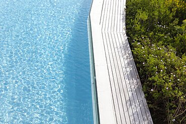 Aerial view of a swimming pool with a paved edge and plants in a garden, Stanford, Western Cape, South Africa