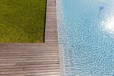 Aerial view of a swimming pool with a decking edge and plants in a garden, Stanford, Western Cape, South Africa