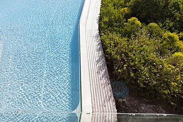 Aerial view of a swimming pool with a paved edge and plants in a garden, Stanford, Western Cape, South Africa