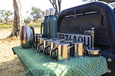 Refreshments stop, a safari vehicle with drinks flasks and mugs laid out, Okavango Delta, Botswana