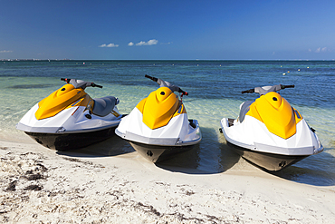 Three jet skis on the beach