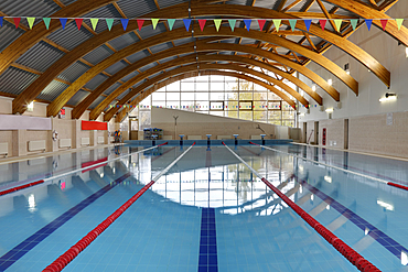 Indoor swimming pool with marked lanes, flat calm water