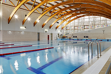 Indoor swimming pool with marked lanes, flat calm water