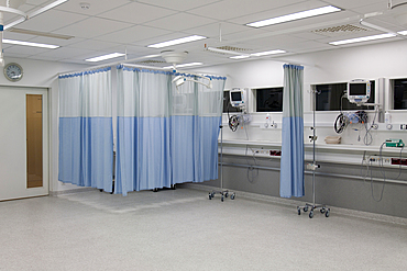 Recovery room in a modern hospital, post-operative recovery, patient bays with curtains