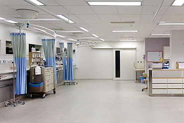 Recovery room in a modern hospital, post-operative recovery, patient bays with curtains