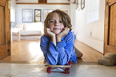 portrait of 8 year old boy with skateboard