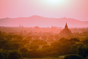 Dawn and mist in the air above temple on the plain in Mandalay, Myanmar