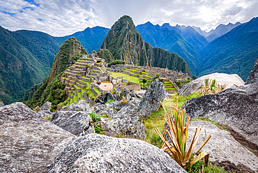 The path to Machu Picchu, the high mountain capital of the Inca tribe, a 15th century citadel site, buildings and view of the plateau and Andes mountains.