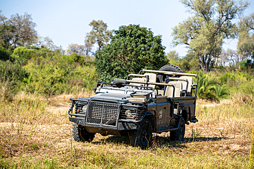 A safari vehicle, parked in the African wilderness.