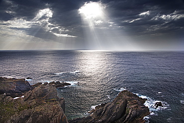 Cabo Sardao coastline in Portugal. Sun streaming through cloud on to the sea, Cabo Sardao, Portugal