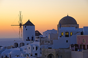 The historic white washed houses, windmills and domed church of Oia town on Santorini island, Oia, Santorini, Greece