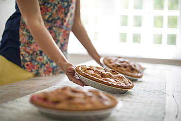 A family gathering. Plates of food being carried to a table. 