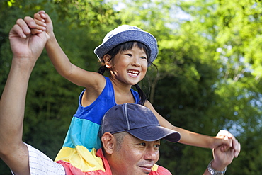 Father carrying his daughter on his shoulders, Kyoto, Honshu Island, Japan