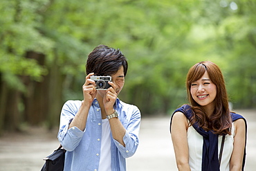 A couple, a man and woman in a Kyoto park, side by side, Kyoto, Honshu Island, Japan