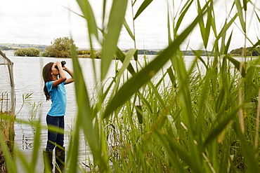 A young girl, a birdwatcher with binoculars, Bristol, Avon, England