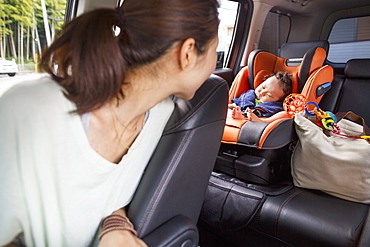 A mother and her young baby boy in a car, Kyoto, Honshu Island, Japan